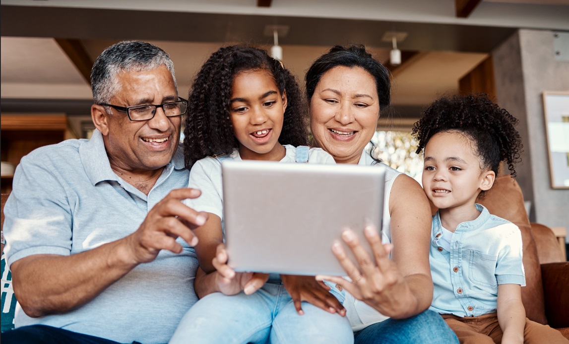 photo of family looking at tablet